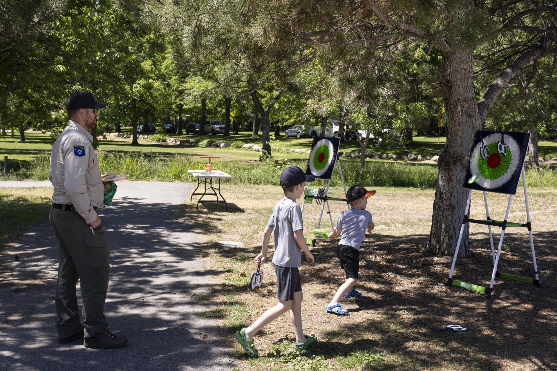 Park ranger and a couple of kids playing in park